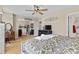 Spacious bedroom featuring a full bed and view of an adjacent sitting area, illuminated by a ceiling fan at 6010 Hawk View Rd, Waxhaw, NC 28173