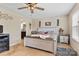 Cozy bedroom with a ceiling fan, complemented by soft lighting, and a view of an attached bathroom at 6010 Hawk View Rd, Waxhaw, NC 28173
