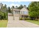 Inviting two-story home boasts a three-car garage, and a well-manicured front lawn at 6010 Hawk View Rd, Waxhaw, NC 28173