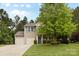 Well-maintained two-story home featuring a three-car garage, and a manicured lawn at 6010 Hawk View Rd, Waxhaw, NC 28173