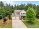Beautiful exterior of a home with a long driveway, a two car garage, and nice landscaping at 6010 Hawk View Rd, Waxhaw, NC 28173