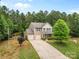 Beautiful home with a two-car garage and an extended driveway in a naturally wooded landscape at 6010 Hawk View Rd, Waxhaw, NC 28173