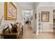 Inviting hallway with hardwood floors, crown molding, and views into the living area of the home at 6010 Hawk View Rd, Waxhaw, NC 28173