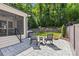 Outdoor patio featuring rocking chairs, landscaping, and a play area in the lush backyard at 6013 Camile Ct, Charlotte, NC 28226