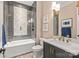 Elegant bathroom featuring a tub, glass shower, and a vanity with marble countertop and modern fixtures at 6013 Camile Ct, Charlotte, NC 28226