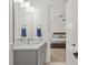 Well-lit bathroom features a gray vanity with a quartz countertop and a view of the bedroom at 6013 Camile Ct, Charlotte, NC 28226