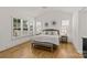 Light and airy bedroom with hardwood floors and shuttered windows at 6013 Camile Ct, Charlotte, NC 28226
