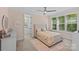 Inviting bedroom features carpet, an upholstered bed, and great natural light from large windows at 6013 Camile Ct, Charlotte, NC 28226