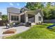 Home's exterior showcasing the white brick, outdoor patio, play area, and lush backyard at 6013 Camile Ct, Charlotte, NC 28226