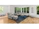 Bright living room with hardwood floors, lots of windows and comfortable sectional sofa at 6013 Camile Ct, Charlotte, NC 28226