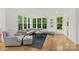 Cozy living room featuring hardwood floors, large windows, and comfortable modern furniture at 6013 Camile Ct, Charlotte, NC 28226