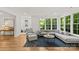 Bright living room features hardwood floors, a large window, and a comfortable gray sectional sofa at 6013 Camile Ct, Charlotte, NC 28226
