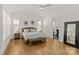 Bright main bedroom with tray ceiling, hardwood floors, and ensuite bathroom access at 6013 Camile Ct, Charlotte, NC 28226
