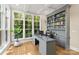 Home office boasts large windows, built-in bookshelves, and a modern desk at 6013 Camile Ct, Charlotte, NC 28226