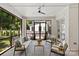 Comfortable screened porch with ceiling fan, seating, white brick and views of fenced-in backyard and patio at 6013 Camile Ct, Charlotte, NC 28226