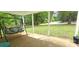Relaxing covered porch with a swing, offering a serene outdoor living space and views of the yard at 6140 Barclay Ln, Clover, SC 29710