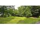Lush, grassy lawn with mature trees providing ample shade and privacy at 6140 Barclay Ln, Clover, SC 29710