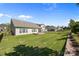 Well-maintained backyard featuring a fire pit, lush lawn and a black metal fence for privacy at 6531 Wildbrook Dr, Charlotte, NC 28269