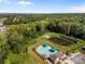 Aerial view of the community pool and clubhouse in a lush, green, wooded area at 6531 Wildbrook Dr, Charlotte, NC 28269