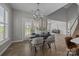 Elegant dining room with modern chandelier, dining table set for four, and access to outdoor area at 6531 Wildbrook Dr, Charlotte, NC 28269