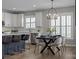 Open-concept design with dining area, kitchen with island seating, and stylish light fixture at 6531 Wildbrook Dr, Charlotte, NC 28269