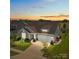 Inviting single-Gathering home showcases beautiful landscaping and a well-manicured lawn at sunset at 6531 Wildbrook Dr, Charlotte, NC 28269