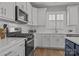 Well-lit kitchen featuring a stainless steel range, white cabinets, and sleek countertops at 6531 Wildbrook Dr, Charlotte, NC 28269
