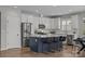 Bright kitchen featuring stainless steel appliances, white cabinets, and a stylish navy island at 6531 Wildbrook Dr, Charlotte, NC 28269
