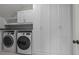 Bright laundry room with washer, dryer, and built-in storage cabinets providing ample space at 6531 Wildbrook Dr, Charlotte, NC 28269