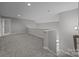 Upstairs living room area with carpet floors and gray walls at 6531 Wildbrook Dr, Charlotte, NC 28269