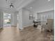 An open concept living area with an office, hardwood floors, and an entrance way with a glass door at 6531 Wildbrook Dr, Charlotte, NC 28269