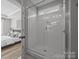 This full bathroom features a shower with white tile at 6531 Wildbrook Dr, Charlotte, NC 28269