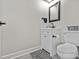 This bathroom features a modern vanity, toilet, and dark accents at 7017 S Providence Rd, Waxhaw, NC 28173