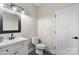 This bathroom features a modern sink, black hardware, and an efficient toilet at 7017 S Providence Rd, Waxhaw, NC 28173