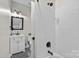 Bright bathroom with a white vanity, dark fixtures, and a tiled shower and tub combo at 7017 S Providence Rd, Waxhaw, NC 28173