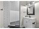 Modern bathroom featuring a walk-in tiled shower and a stylish vanity with a dark-framed mirror at 7017 S Providence Rd, Waxhaw, NC 28173