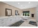 Bathroom featuring double vanities, a soaking tub and neutral paint at 7017 S Providence Rd, Waxhaw, NC 28173