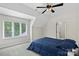 This bedroom features a window, a ceiling fan, neutral paint, and carpet at 7017 S Providence Rd, Waxhaw, NC 28173