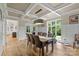 The well-lit dining room features a coffered ceiling, wainscoting, and wood flooring at 7017 S Providence Rd, Waxhaw, NC 28173
