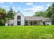 Beautiful white brick home with a spacious backyard and covered porch, perfect for entertaining at 7017 S Providence Rd, Waxhaw, NC 28173