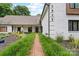 Inviting home with a brick walkway, attractive landscaping, and a classic painted brick facade at 7017 S Providence Rd, Waxhaw, NC 28173