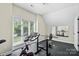 Bright home gym with large window, exercise equipment, and mirrored wall at 7017 S Providence Rd, Waxhaw, NC 28173