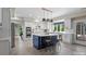 Bright, eat-in kitchen features white cabinetry, stainless appliances, subway tile backsplash, and large blue center island at 7017 S Providence Rd, Waxhaw, NC 28173