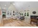 Spacious living room with a vaulted ceiling, fireplace, built-ins, and hardwood flooring at 7017 S Providence Rd, Waxhaw, NC 28173