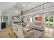 Open-concept living room with hardwood floors, staircase, and lots of natural light at 7017 S Providence Rd, Waxhaw, NC 28173