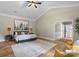 This primary bedroom features a ceiling fan, hard wood floors and natural light at 7017 S Providence Rd, Waxhaw, NC 28173