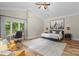 The main bedroom features a ceiling fan, hard wood floors and neutral walls at 7017 S Providence Rd, Waxhaw, NC 28173