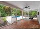 Inviting outdoor patio with brick flooring, overlooking the pool and lush backyard at 7017 S Providence Rd, Waxhaw, NC 28173