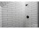Close-up of the tiled shower featuring dark fixtures and white rectangular tiles at 7017 S Providence Rd, Waxhaw, NC 28173