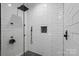This shower has white subway tile, black fixtures, and a glass door at 7017 S Providence Rd, Waxhaw, NC 28173